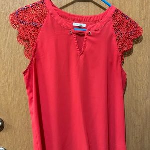 Orange blouse with short sleeve capped lace shoulders. Business casual.